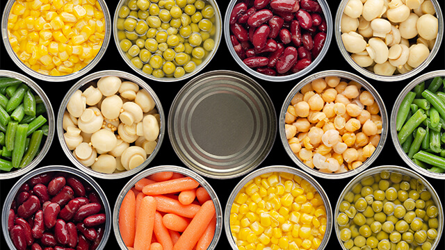 Opened cans of chickpeas green sprouts crrots corn peas beans mushrooms
