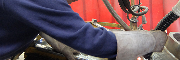 Close-up of man's arm troubleshooting a heat exchanger